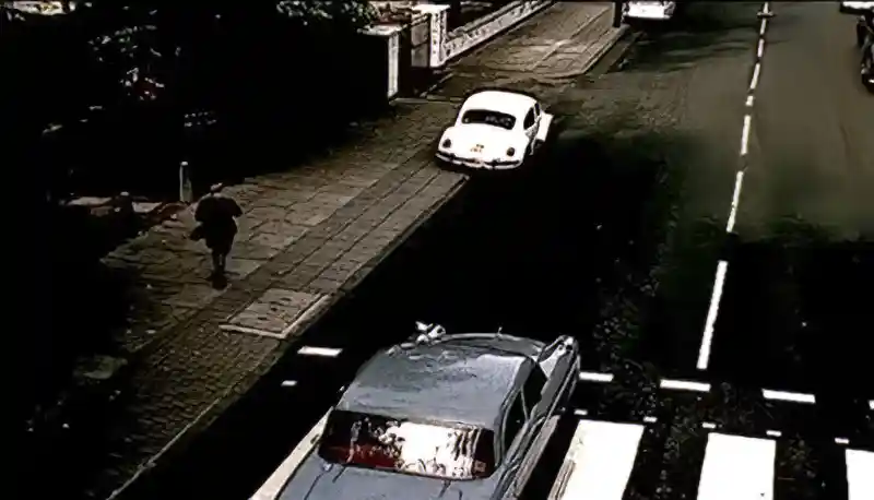 Song Titles In Free As A Bird - Abbey Road zebra crossing with passing car