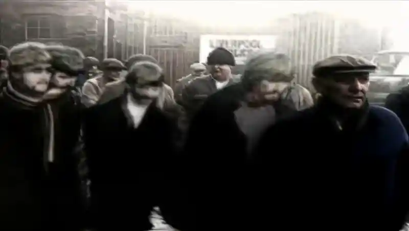Liverpool dockworkers walking through the docks in the Free As A Bird video