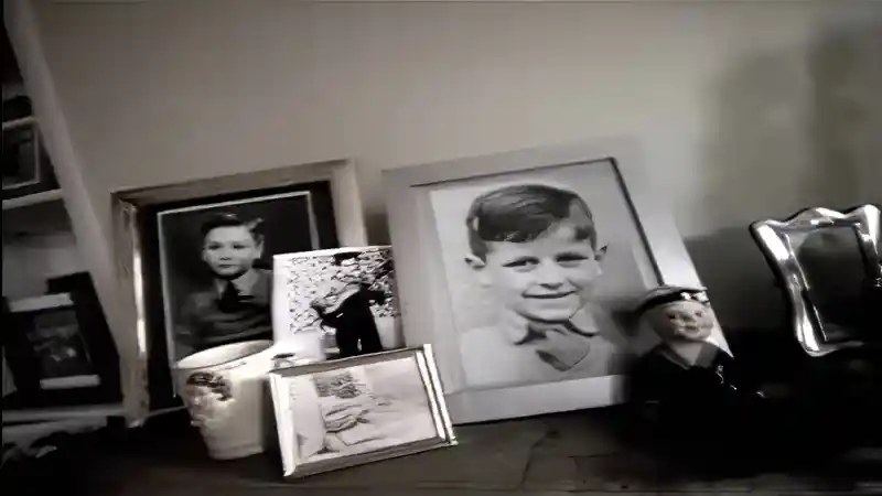 Mantelpiece with framed childhood photos in the opening home scene