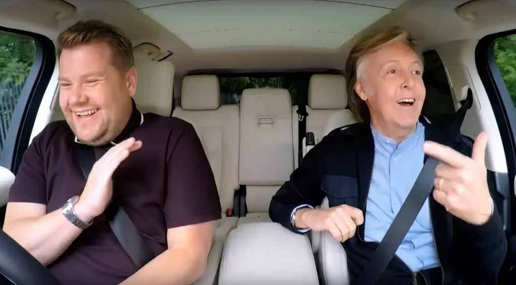 Paul McCartney and James Corden laughing in the car during Carpool Karaoke in Liverpool