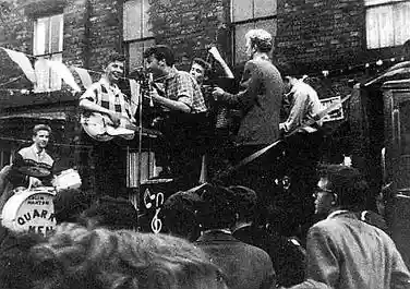 The Quarrymen performing on the back of a coal lorry in Rosebery Street, Liverpool, on 22 June 1957